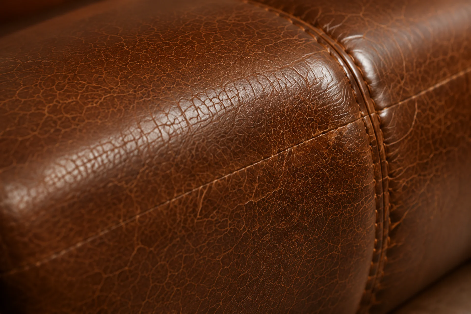 Aniline leather on a commercial armchair showing absorbed staining before repair