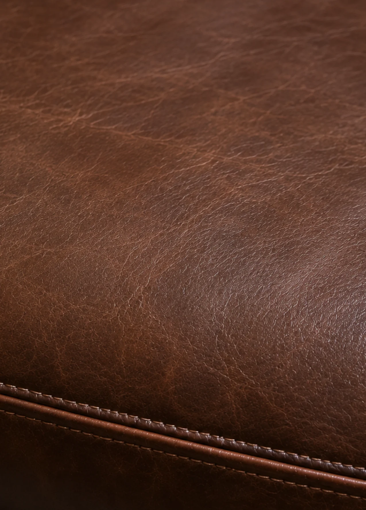 Protected pigmented leather restaurant booth with a repaired stitched seam