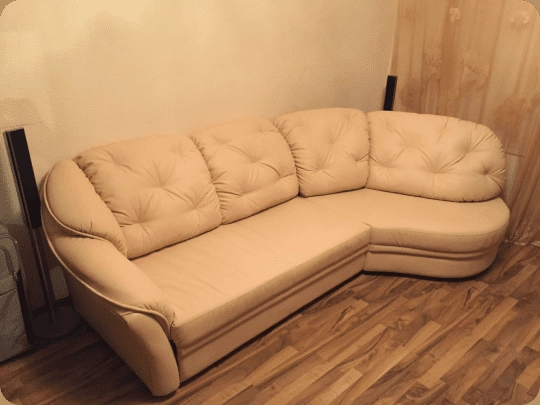 Beige leather corner sofa fully restored and reupholstered after repair service in New York