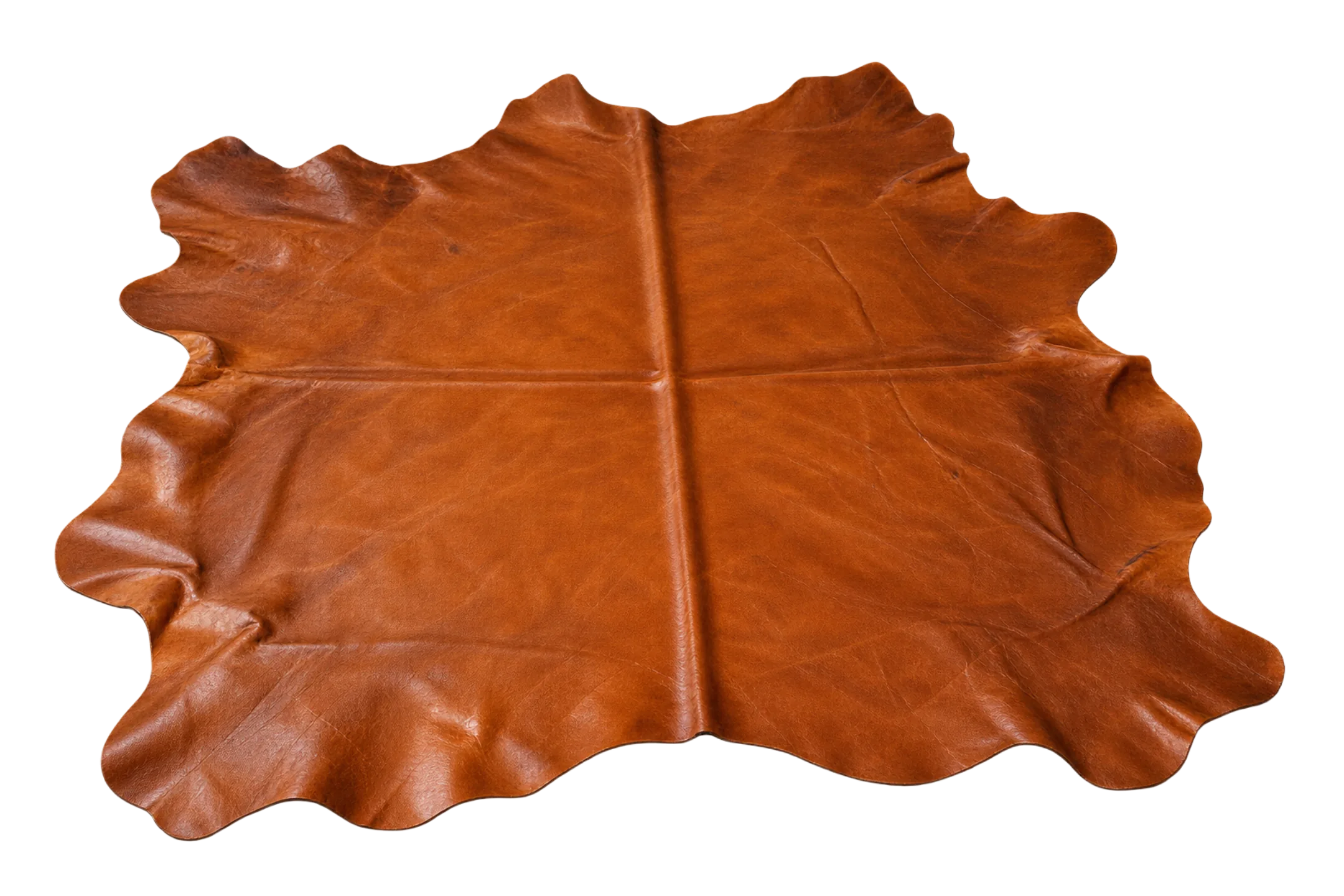 A full aniline leather hide laid flat, showing the irregular natural outline a roll of fabric does not have