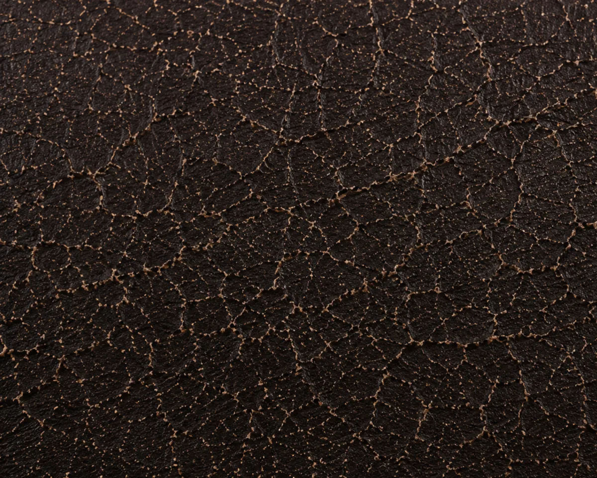 Macro of bonded leather at the micro-cracking stage, a fine network of hairline fractures across the finish