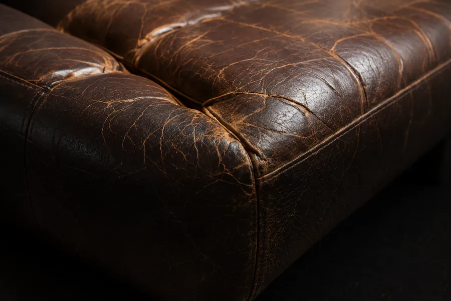 Faded and cracking brown leather seating in need of color restoration