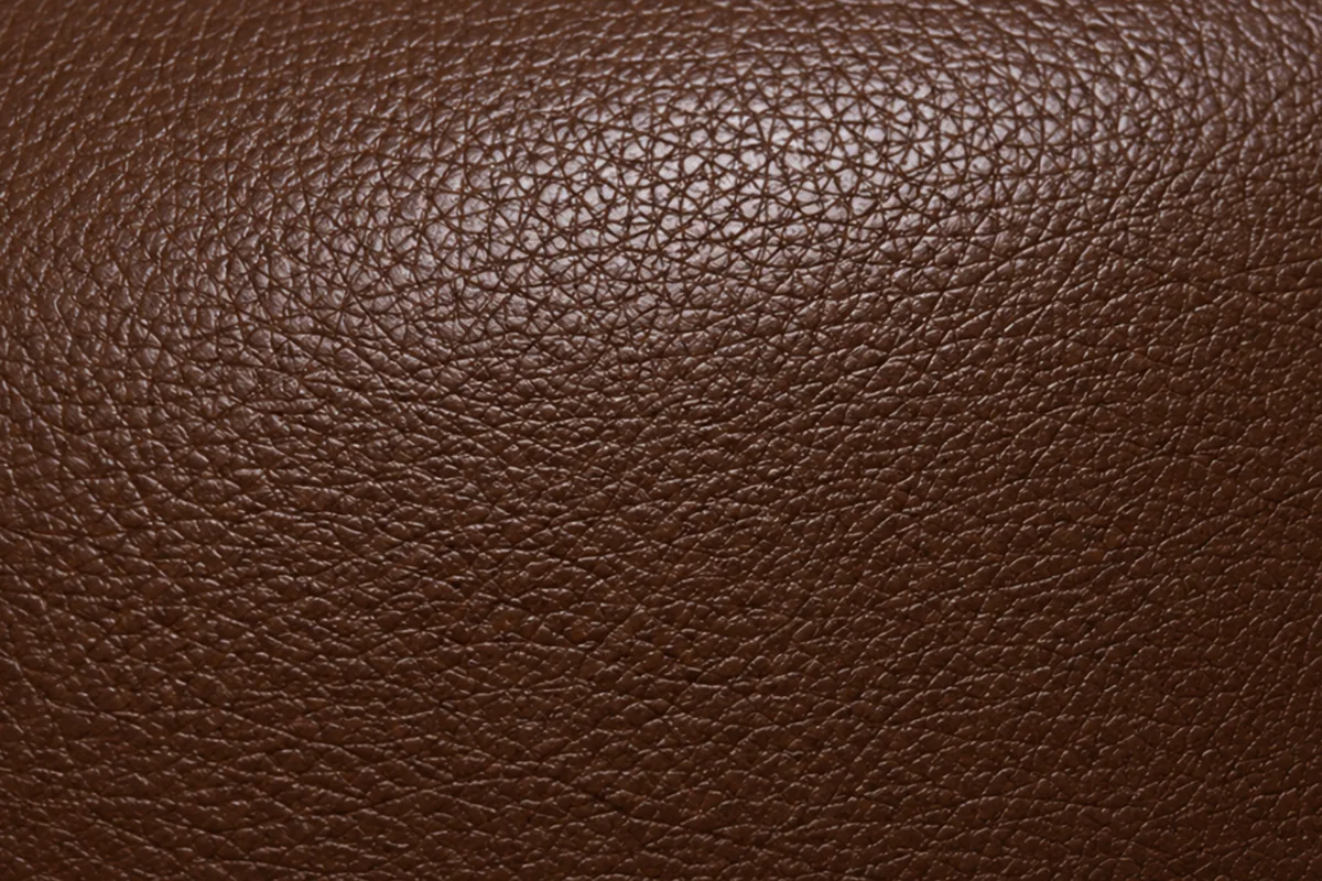 The same embossed grain sealed under an opaque pigment coat, with an even colour and a low sheen