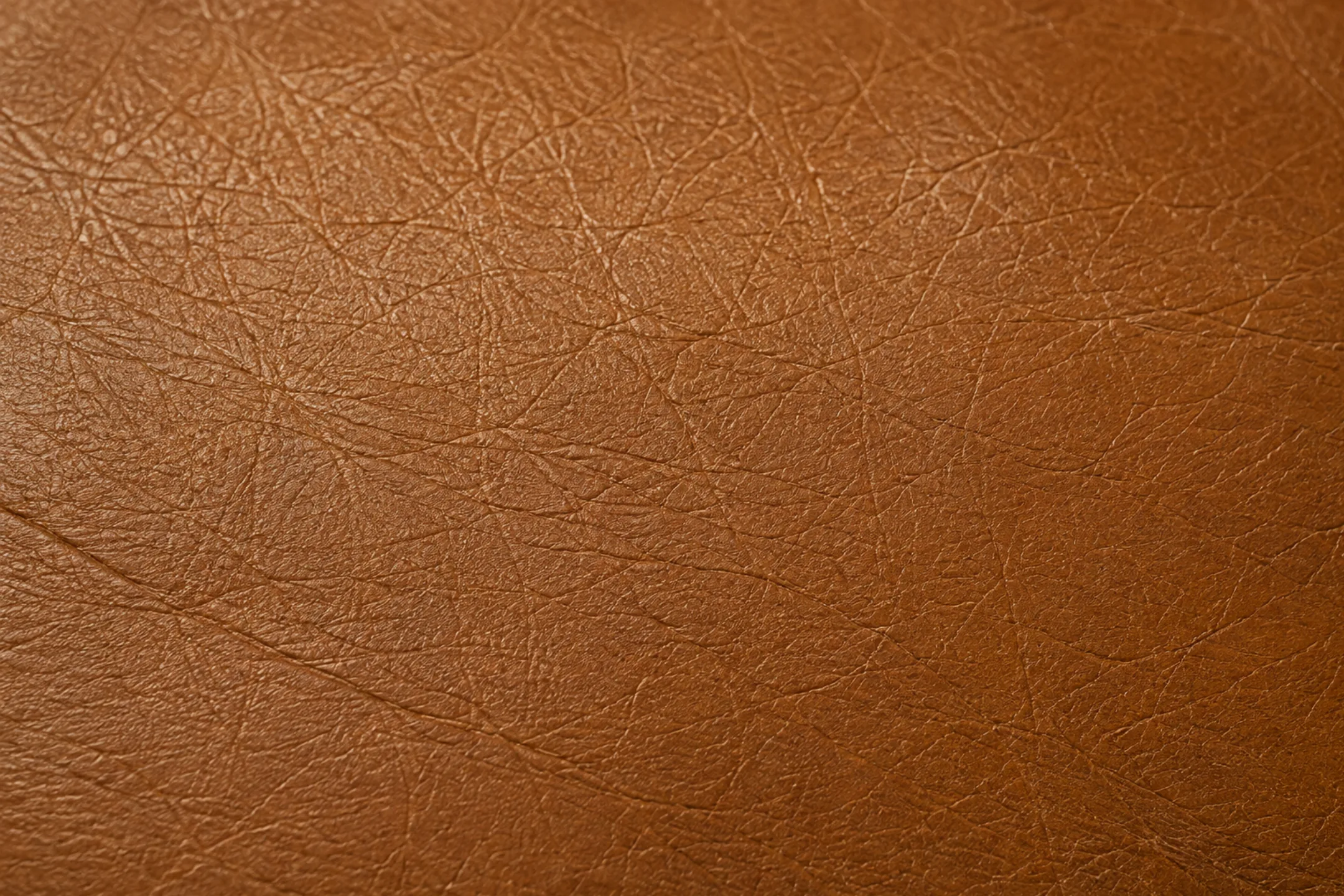 Dried out aniline leather that has stiffened and started to fissure at a flex point