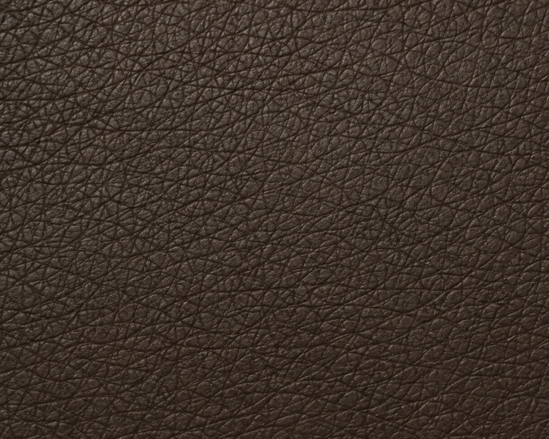 An even pebble grain across dark brown faux leather, printed from a plate so the pattern repeats