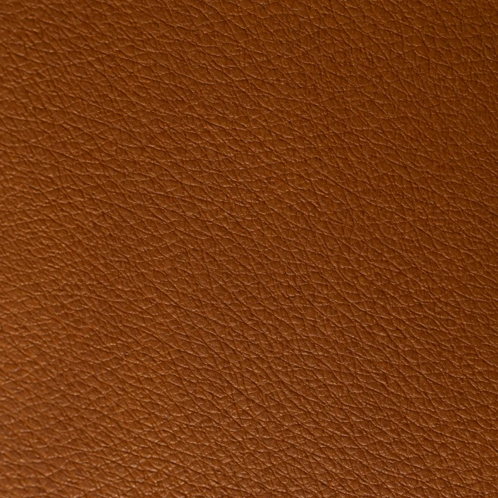A rust-coloured pleather swatch, the informal name for a PVC-coated textile