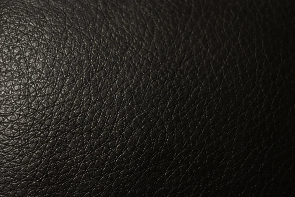 Faux leather swatch — near-black embossed grain used on bar seating