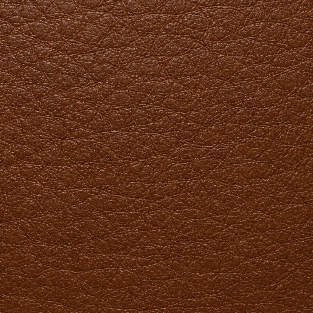 A chestnut synthetic leather swatch, a polymer surface embossed to imitate hide grain