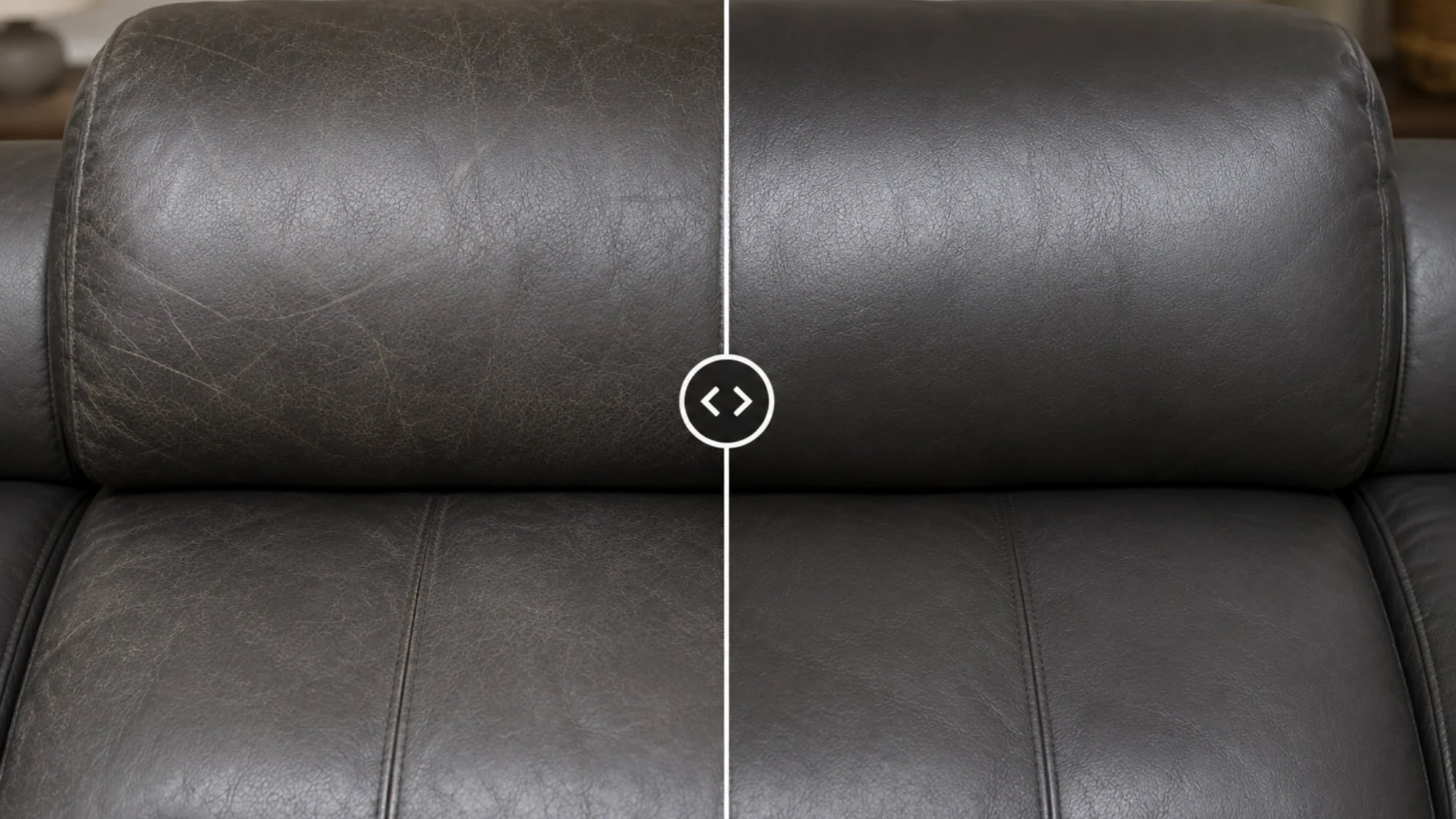 Grey leather sofa headrest and seat, scuffed and crazed on the left half, even matte grey on the right half.