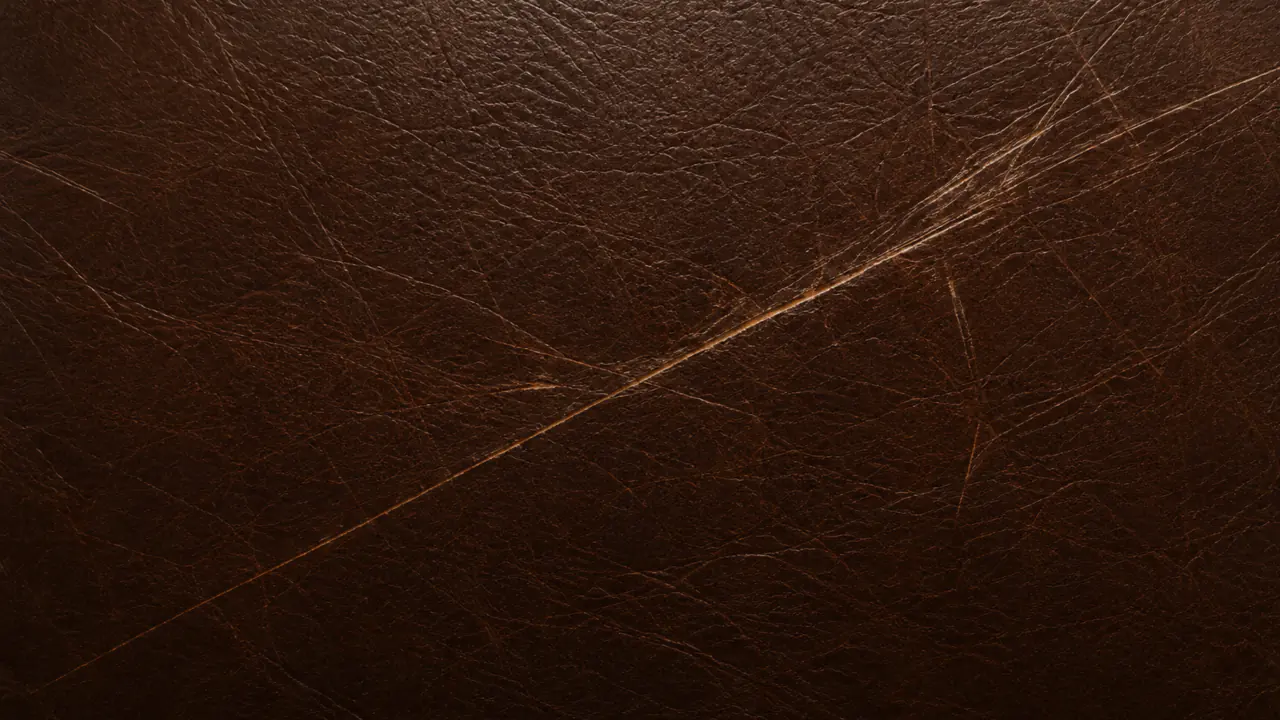 Macro of leather cut by deep scratches that have broken the surface.