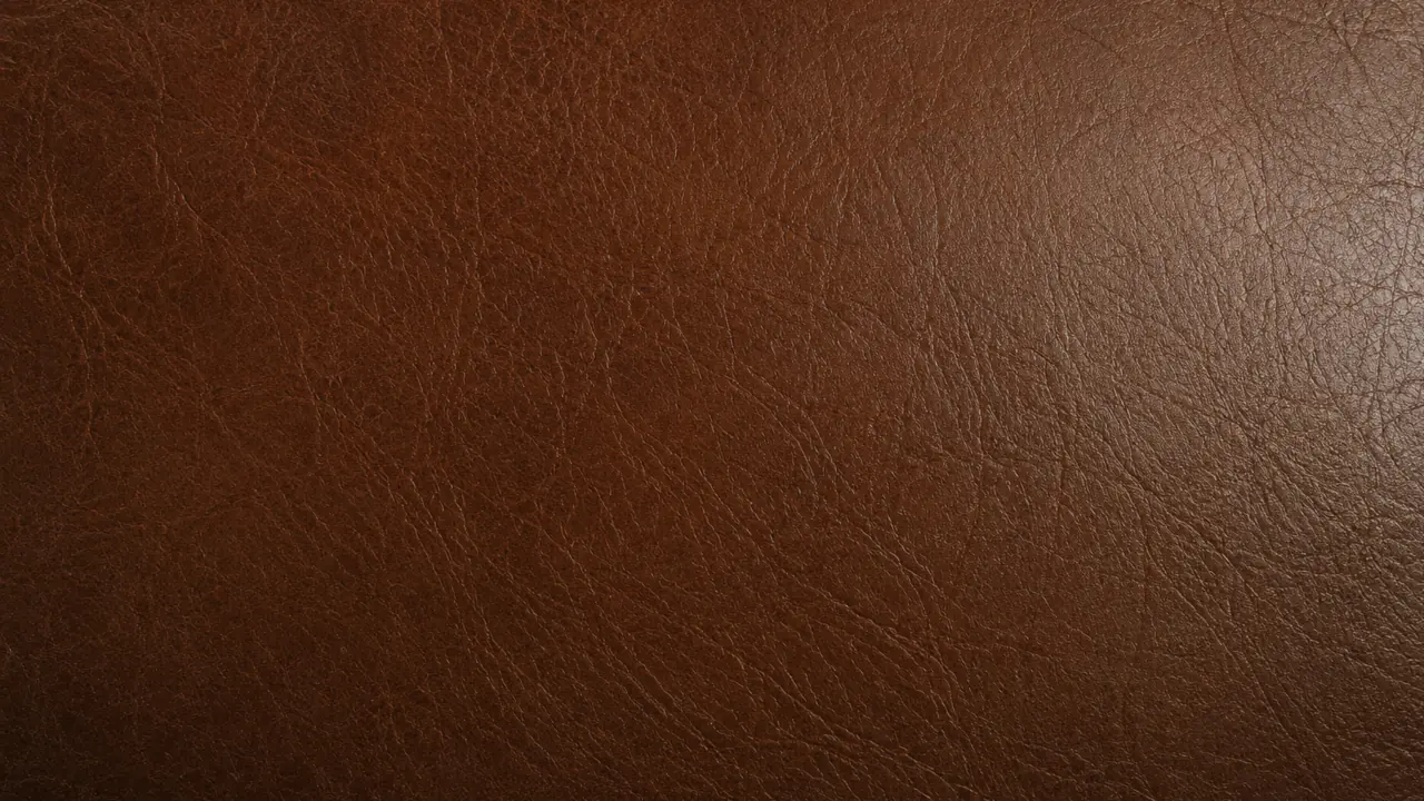 Macro of leather faded pale and flat across a panel.