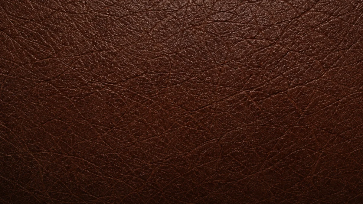 Close view of protected leather from the shaded end of a sofa, still deep in color