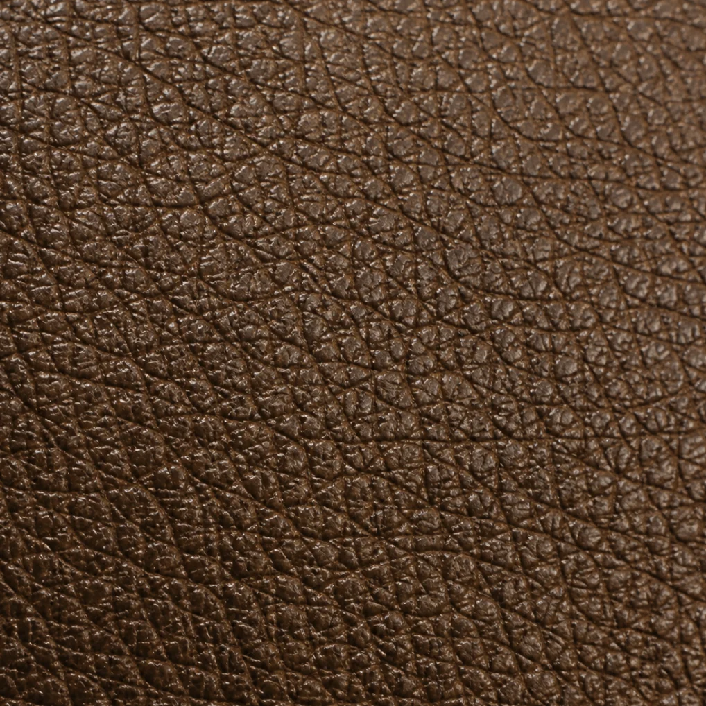 Close view of brown pigmented leather showing its pebble grain
