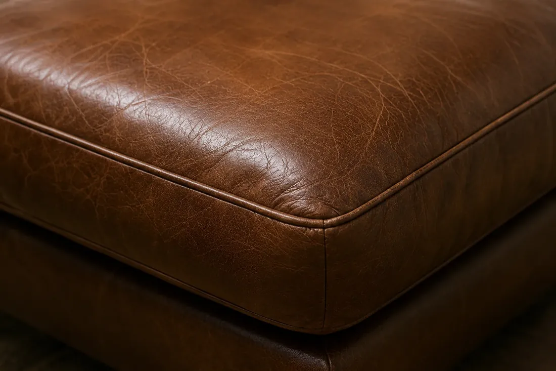 Brown leather seat cushion after hotel furniture restoration NYC, colour and sheen even across the panel