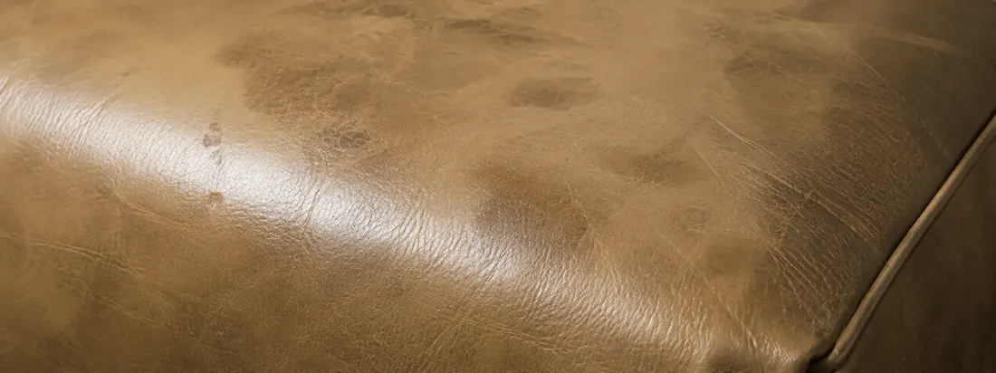 Leather seat with a glossy burnished patch from body oils