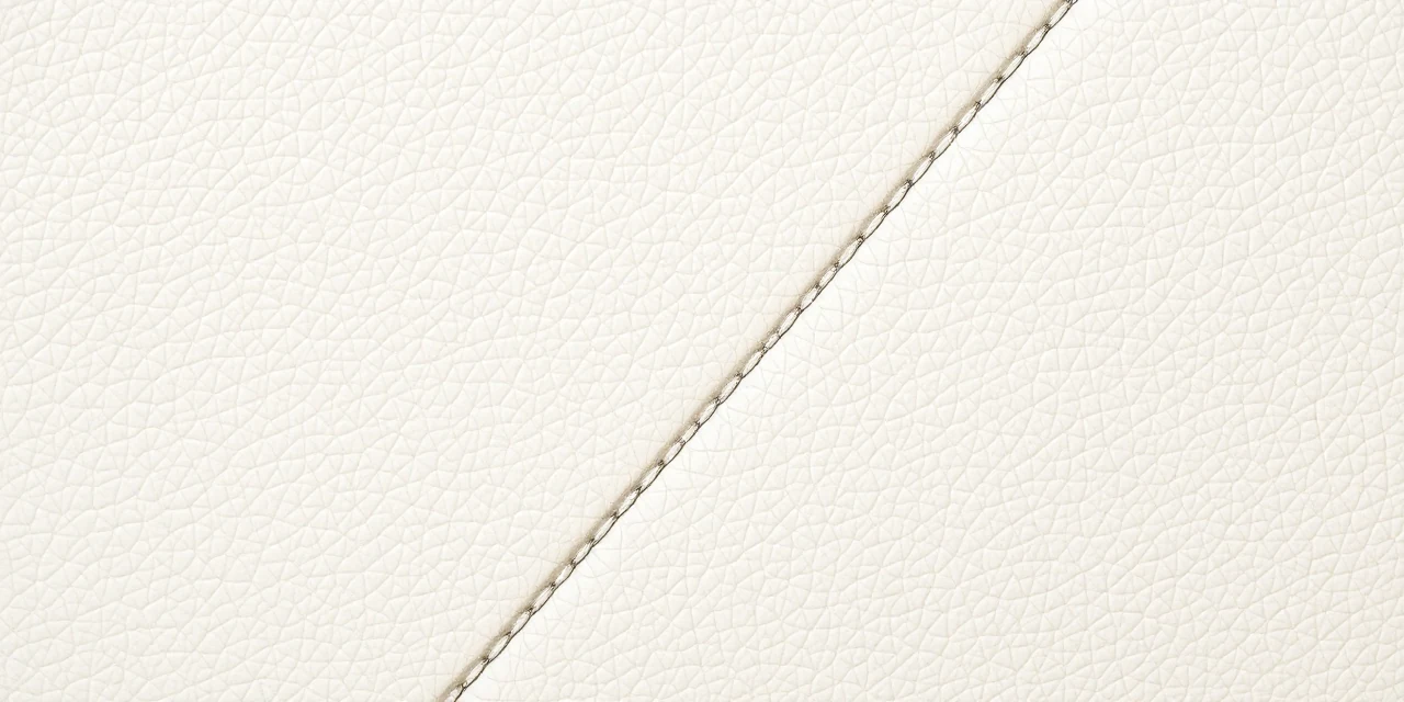 Cream white leather upholstery panel with a single stitched seam running across it