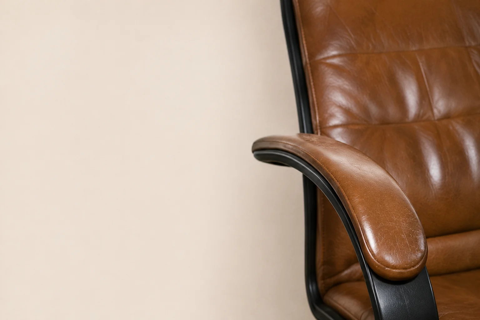 Armrest of a leather office chair being re-pigmented