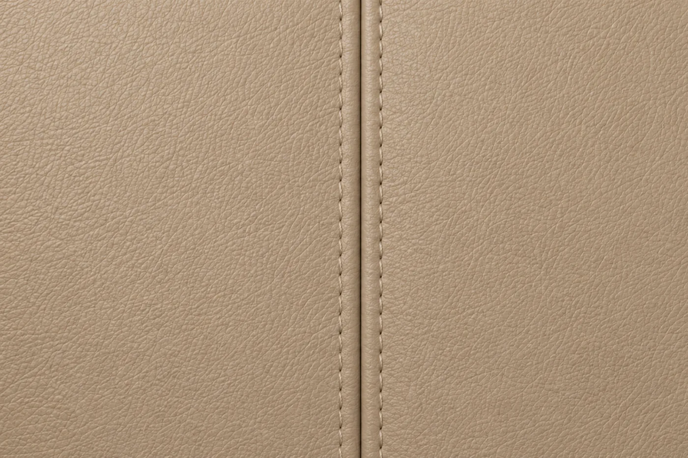 Two leather panels meeting at a seam, the comparison a colour match has to survive