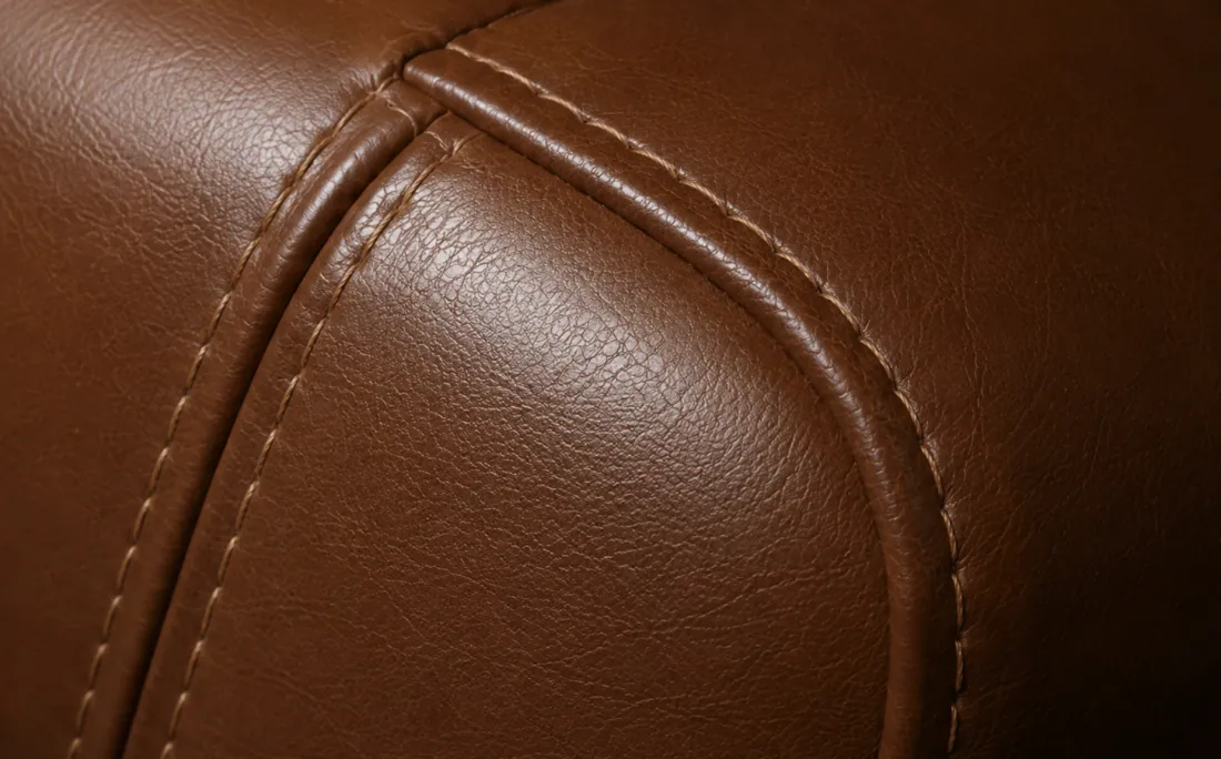 Leather panel replacement sewn into the same seam line, matched for colour and grain