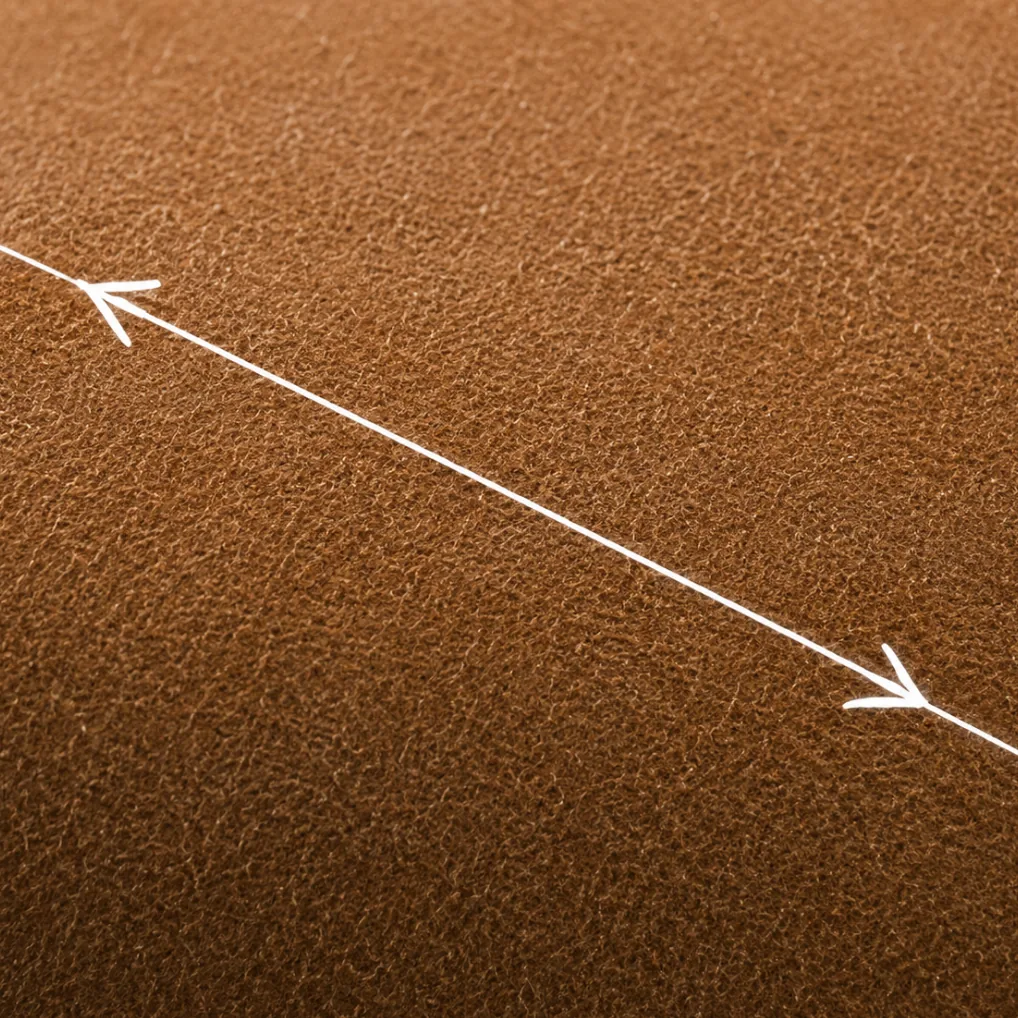 An arrow drawn across a nubuck panel showing the direction the nap runs