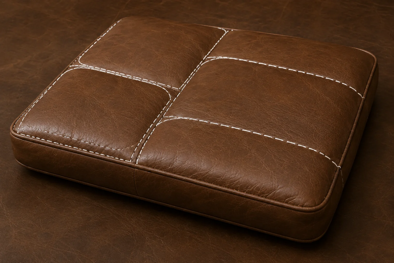 A stitched leather cushion showing how the seat is divided into separate sewn panels