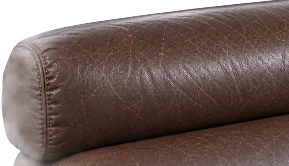 Close-up of a bonded leather headrest bolster with fine surface crazing along the piped seam