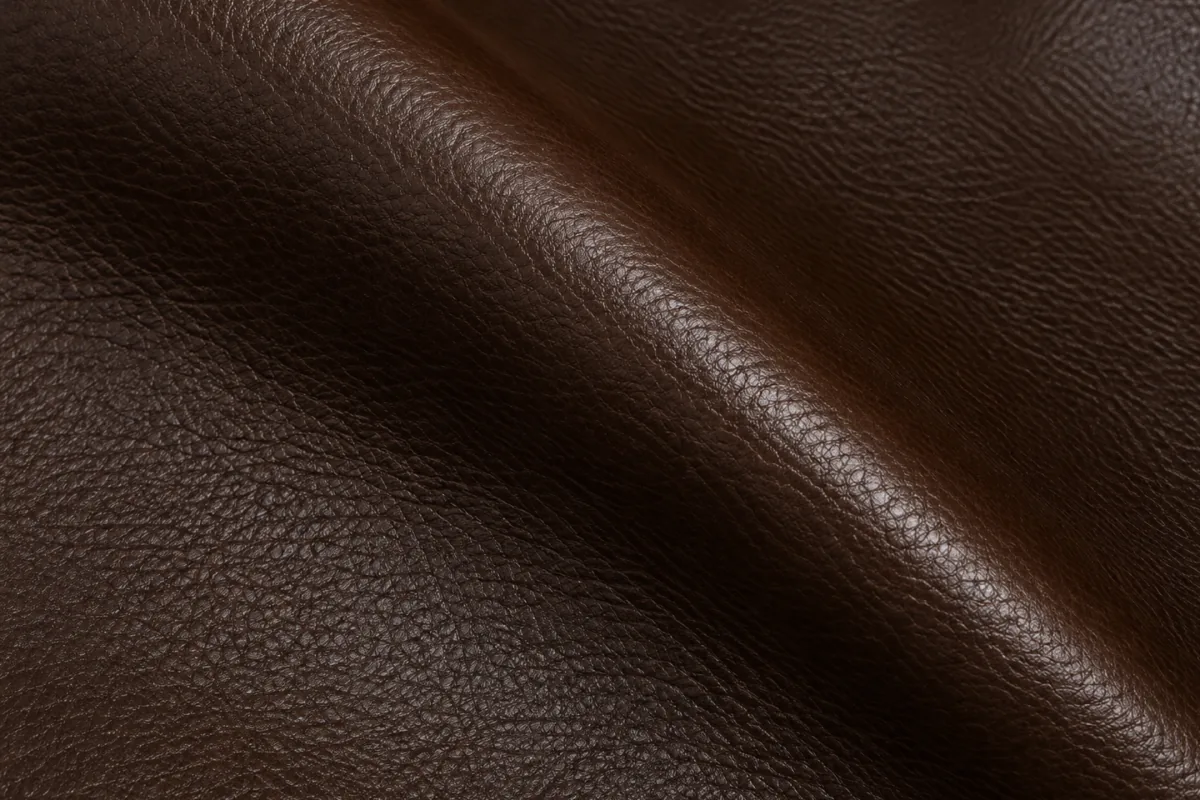 Pigmented leather swatch with a protective colored surface coating