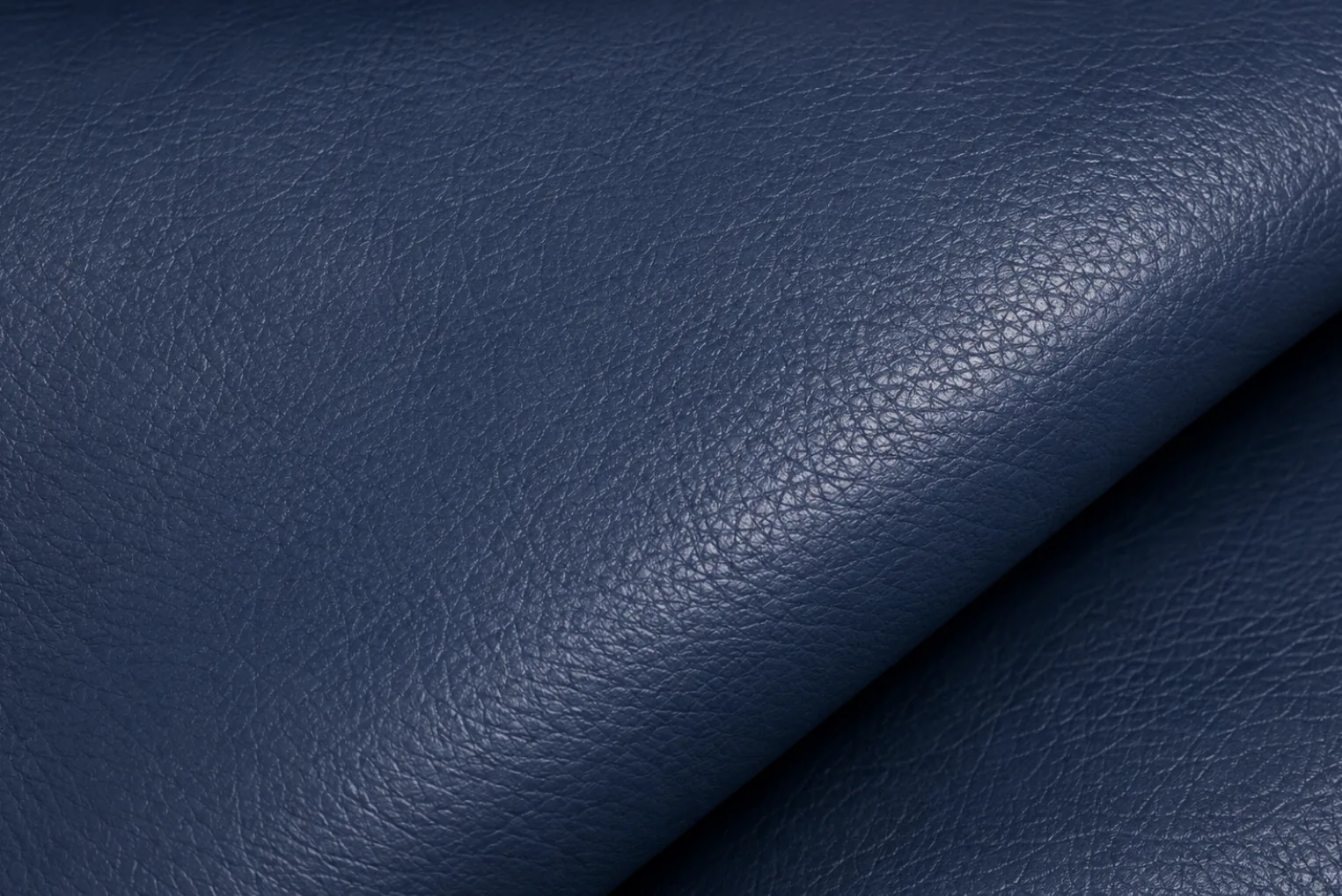 A folded navy PU faux leather panel, the more breathable of the two coatings