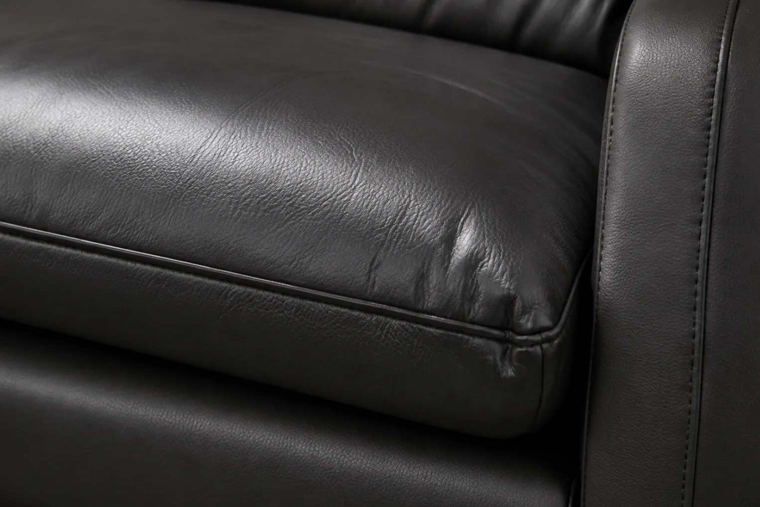 A black PVC vinyl sofa cushion with a sealed, non-porous surface