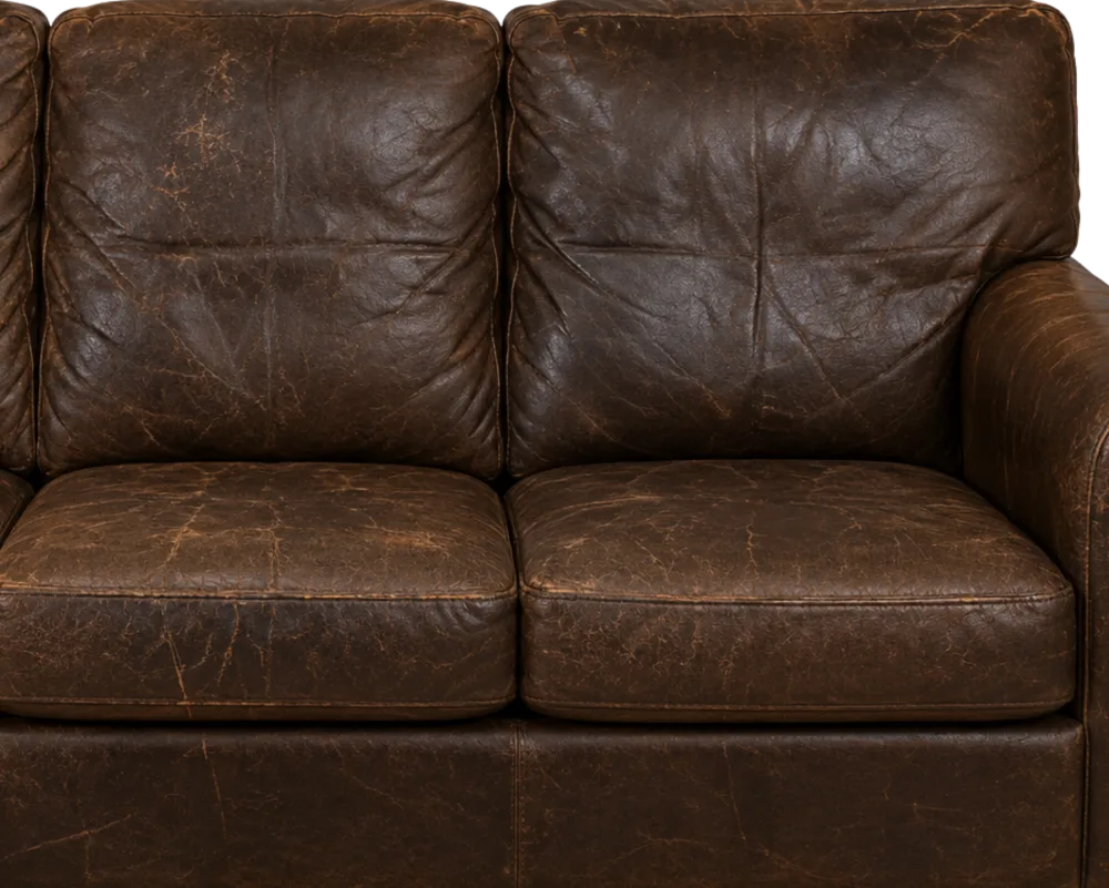 A leather loveseat where every panel has aged and cracked, not just one