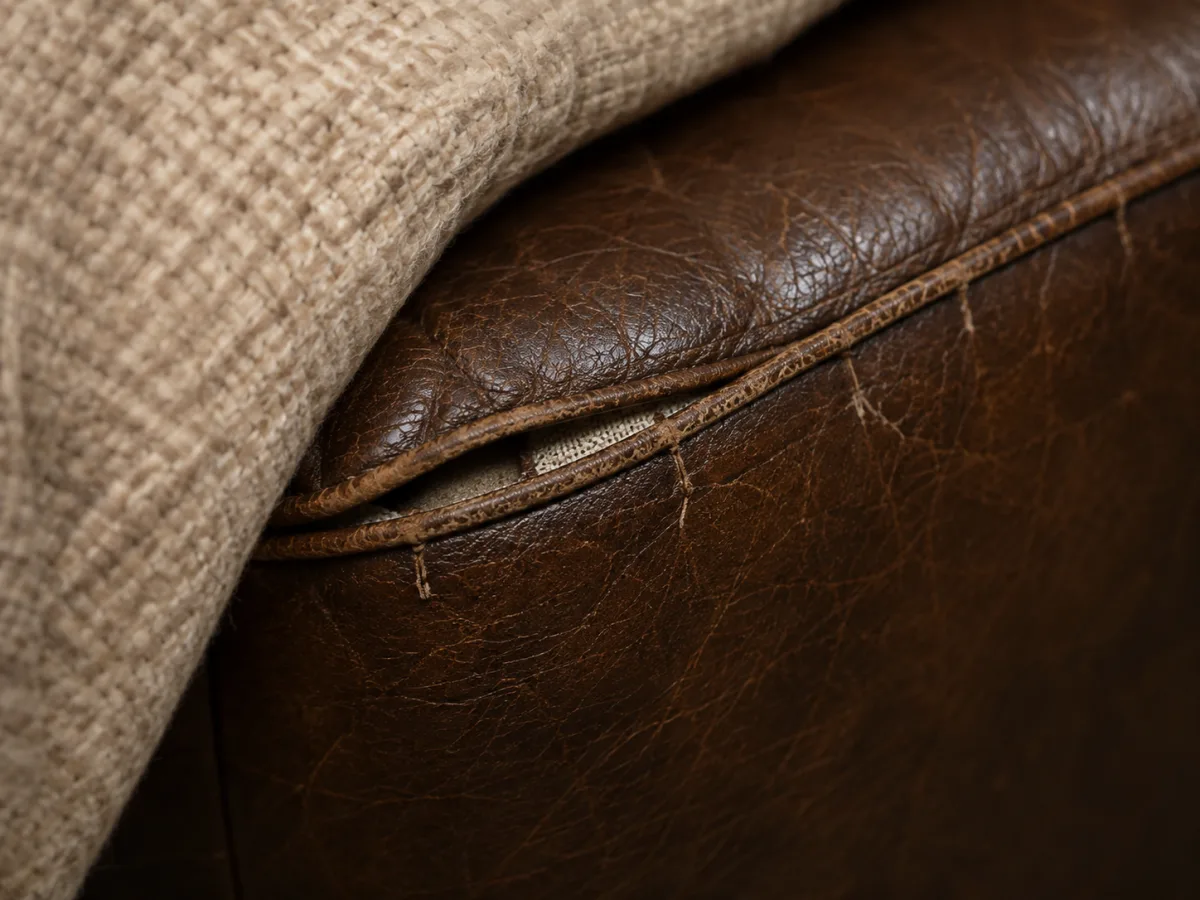 Loose sagging upholstery on a brown leather restaurant seat