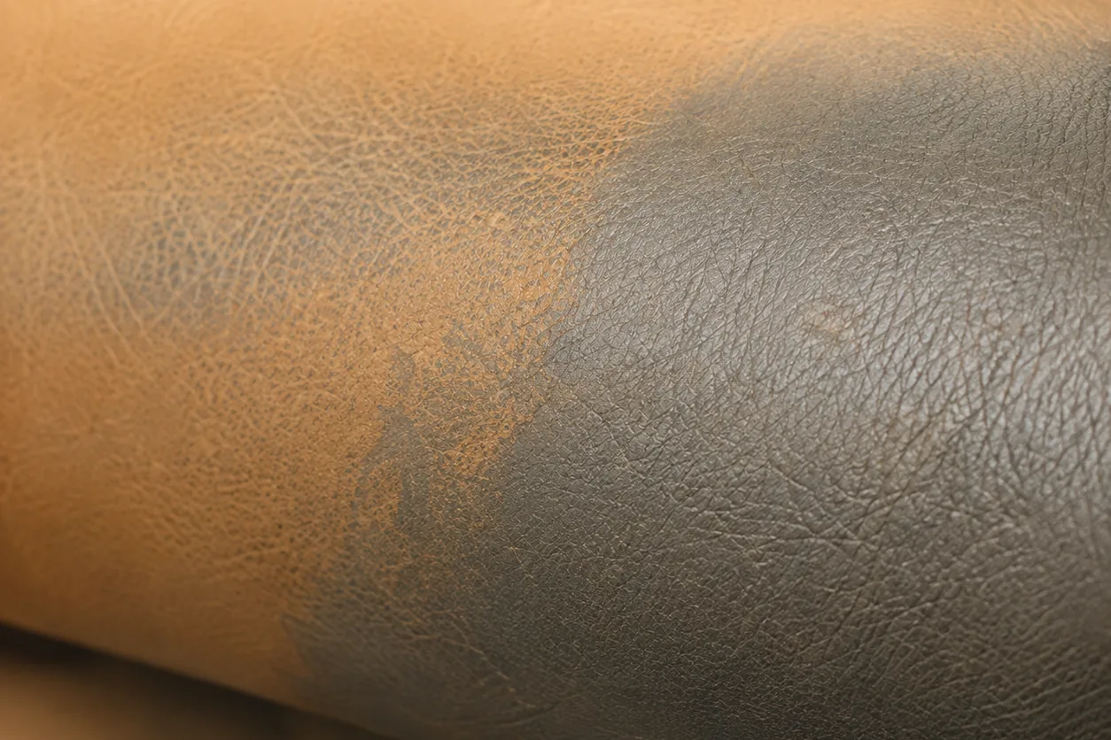 A restaurant seat roll half tan and half grey where the colour has gone uneven across one panel