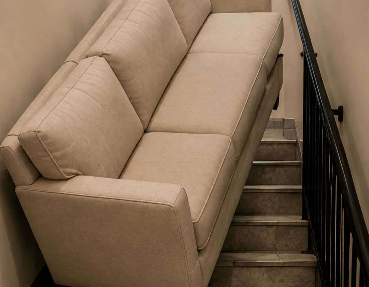 A sofa wedged in a narrow stairwell that cannot clear the turn to be collected