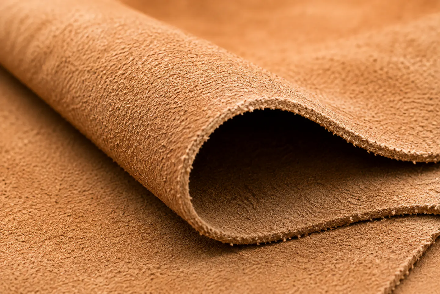 A raw split hide folded back on itself, open fibre on both faces, no grain and no finish