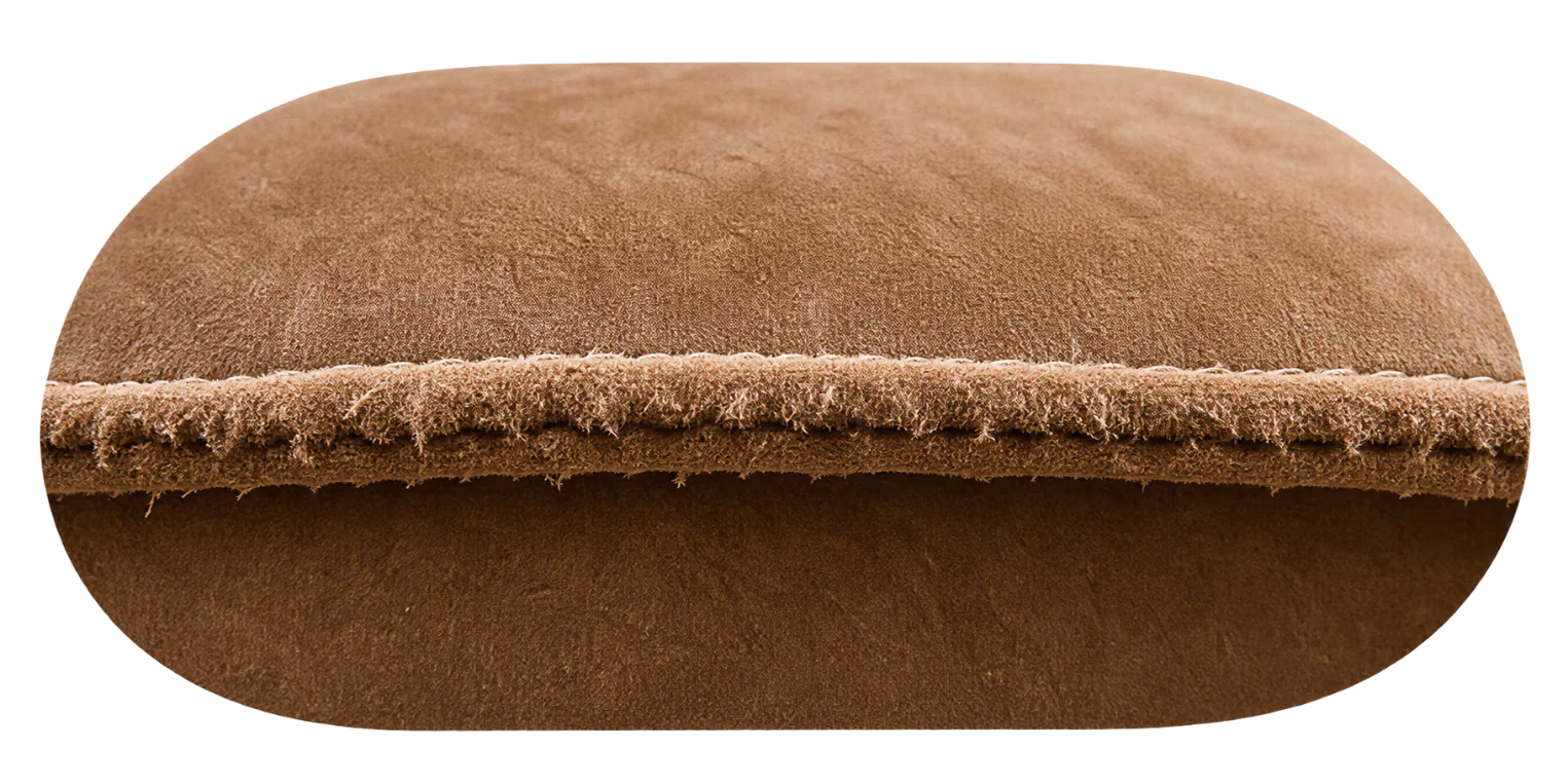 Cut edge of a suede panel: solid and slightly furry, the same fibre right through with nothing woven to unravel