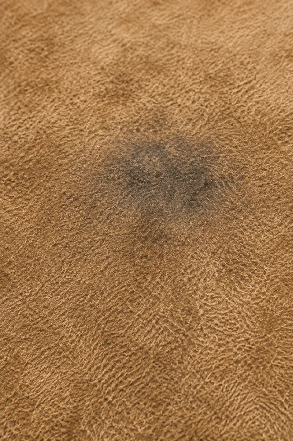 A grey-blue cast sitting in the nap of pale suede, colour that arrived from denim rather than from the hide
