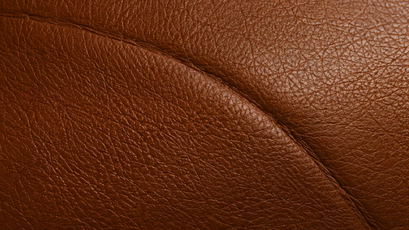 Top-grain leather surface after light buffing, the grain even and the strongest markings gone but pores still visible