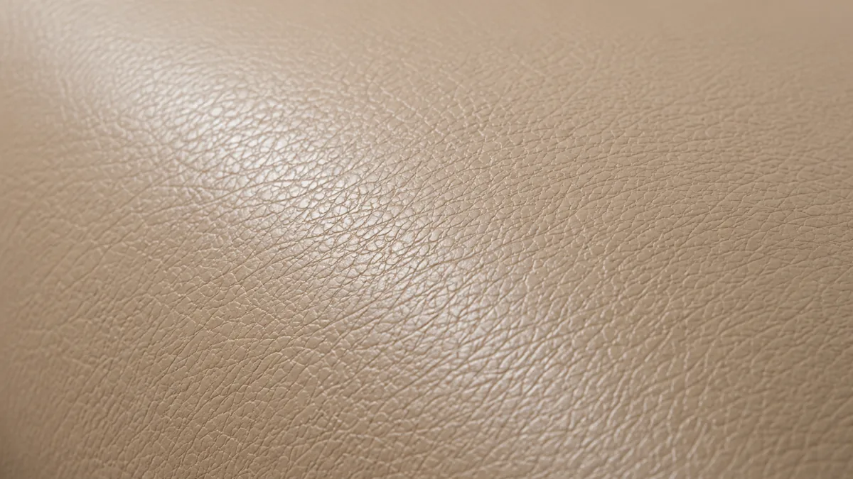 Sealed and cured top-grain leather, the grain still readable and the sheen even across the panel