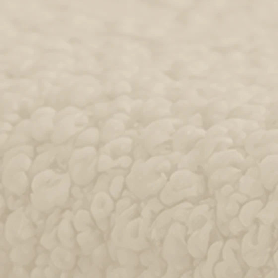 Bouclé upholstery fabric texture in a pale sand color