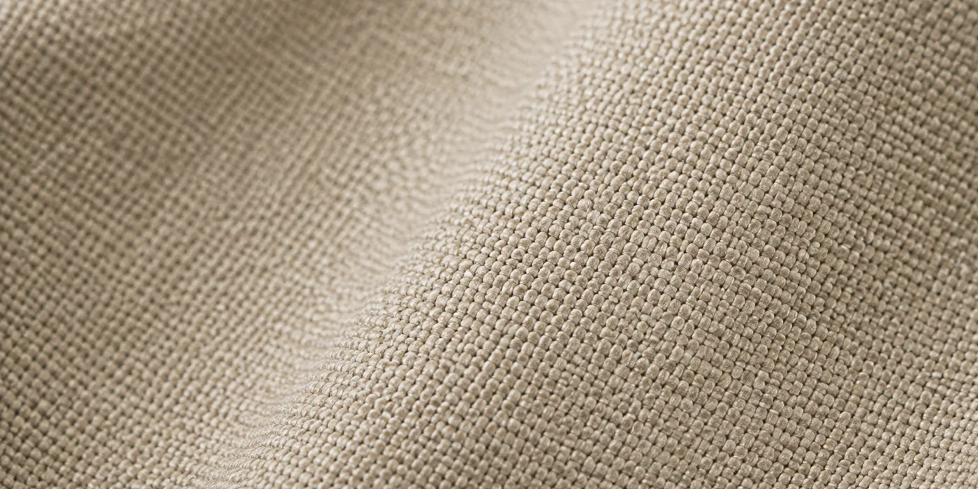 Macro view of pale taupe olefin upholstery fabric showing its flat woven face