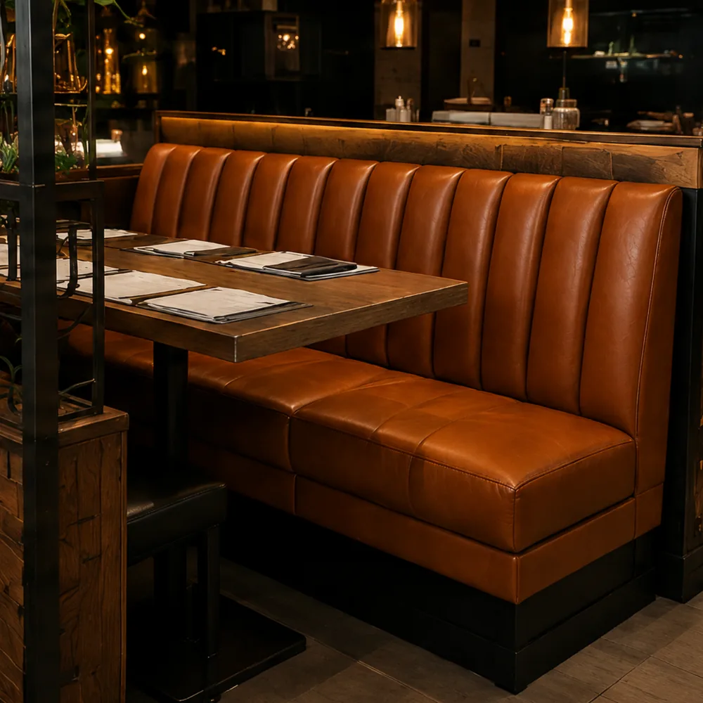 Finished restaurant banquette run reupholstered in tan leather with the tables reset