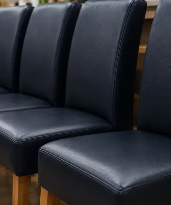 Matched navy vinyl dining chairs