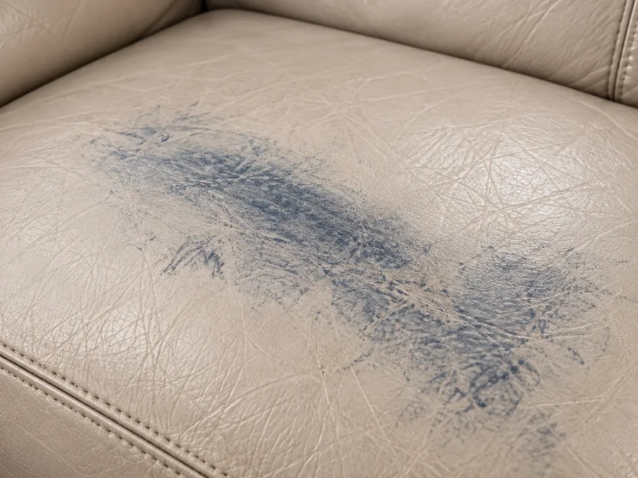 Blue denim dye transferred onto a cream leather seat cushion