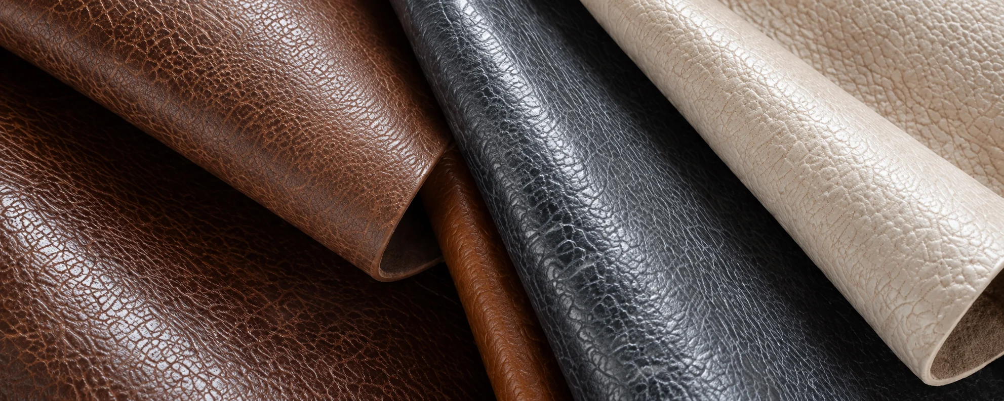 Rolled upholstery hides in brown, black and cream