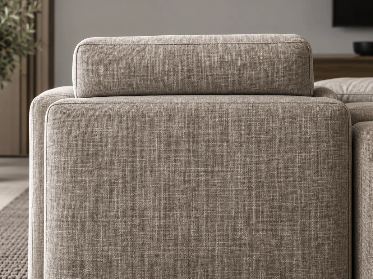 Sofa back sewn to the frame with a headrest bolster above it
