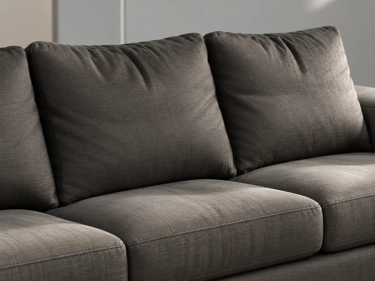 Two loose back cushions on a dark grey fabric sofa