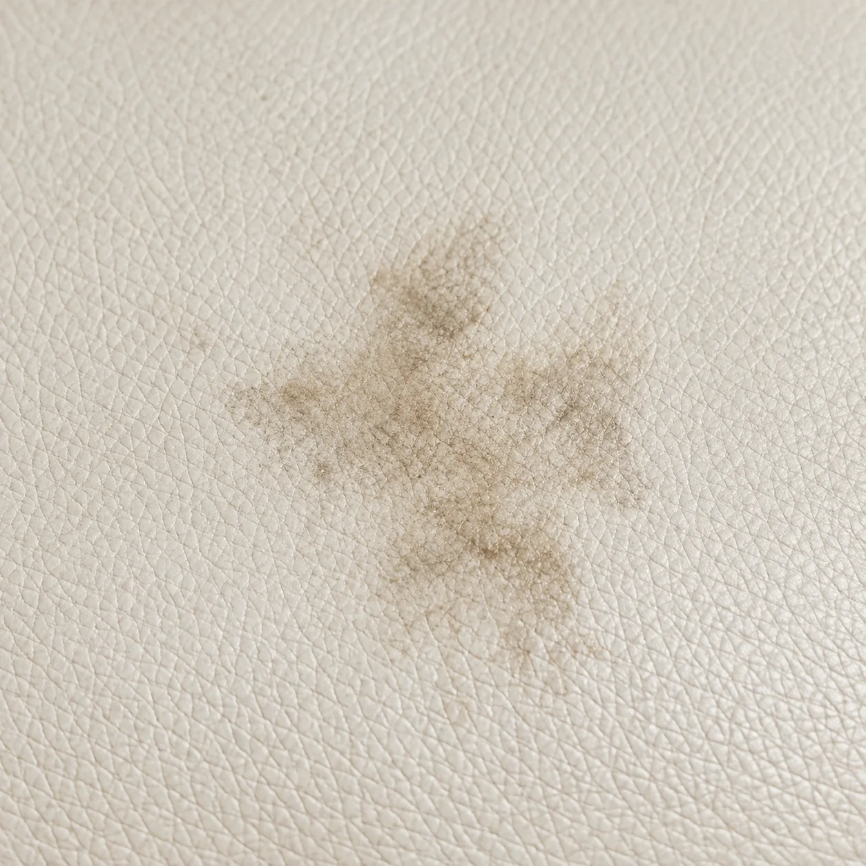 Staining across a light leather cushion