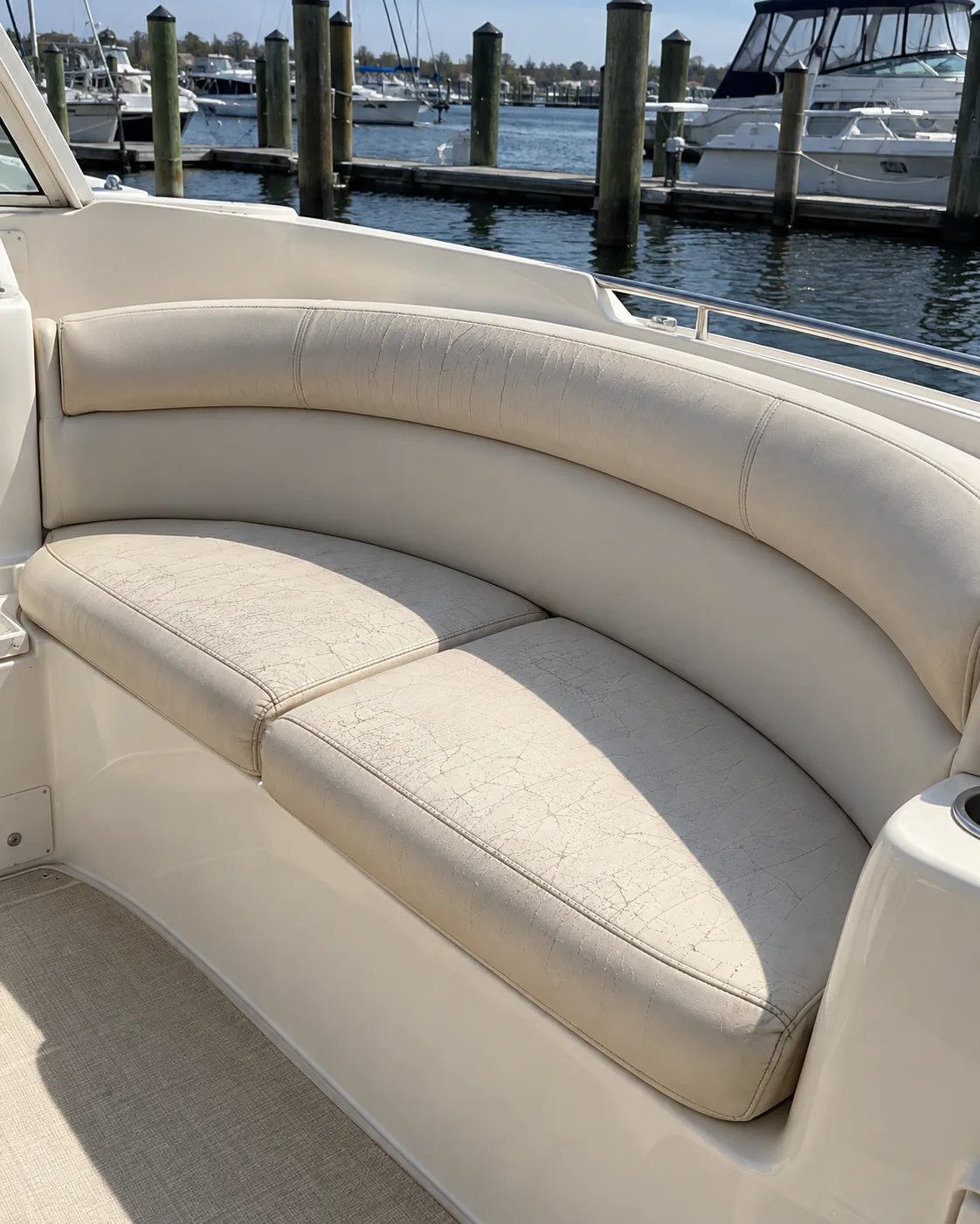 A boat bench cushion with cracked chalky vinyl