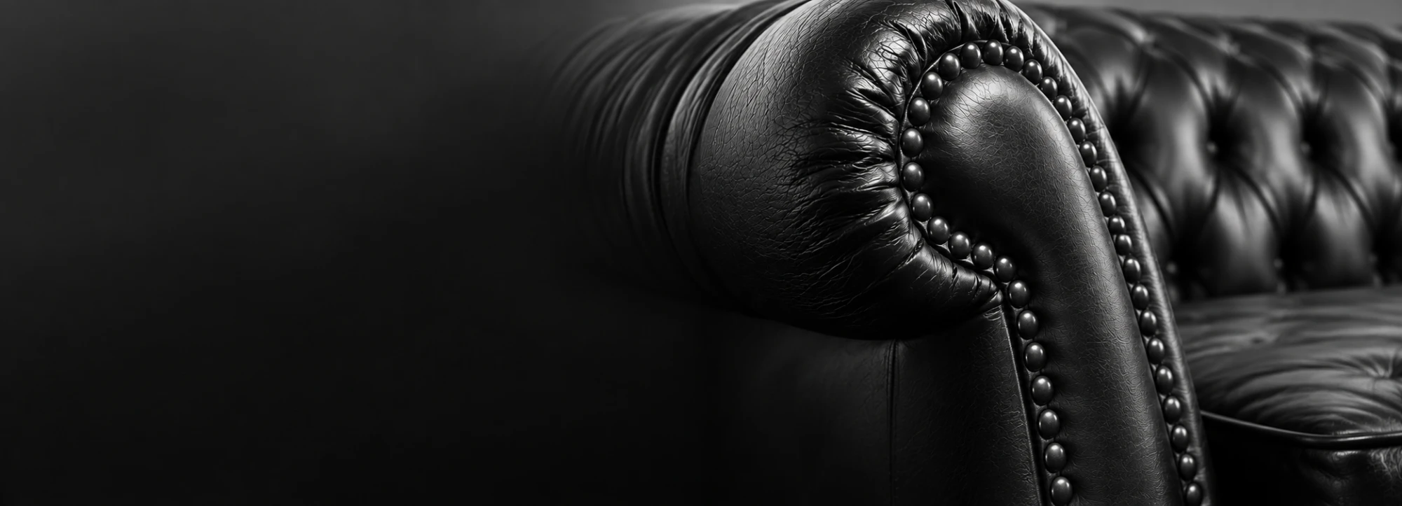 Black leather chesterfield sofa arm