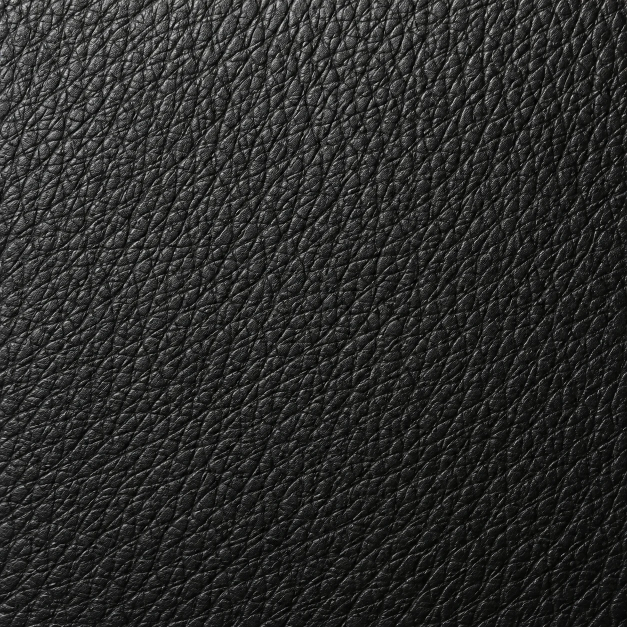 Evenly lit close-up of black leather grain, the colour reference we match to